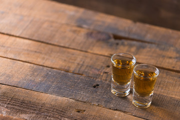 whiskey in glass on wood background