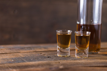 whiskey in glass on wood background