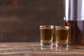 whiskey in glass on wood background