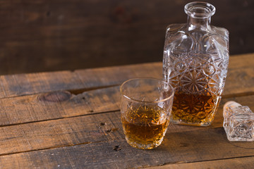 whiskey in glass on wood background