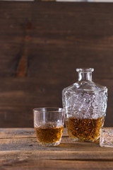 whiskey in glass on wood background