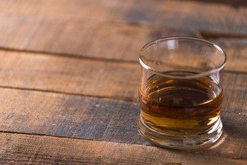 whiskey in glass on wood background