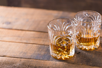 whiskey in glass on wood background
