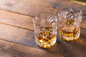 whiskey in glass on wood background