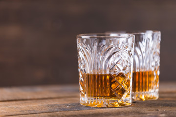 whiskey in glass on wood background