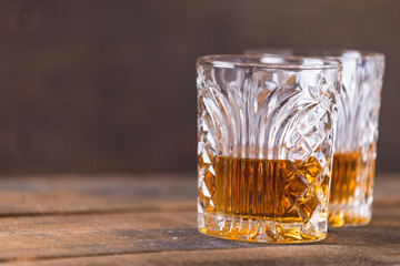 whiskey in glass on wood background