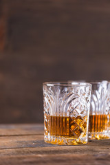 whiskey in glass on wood background