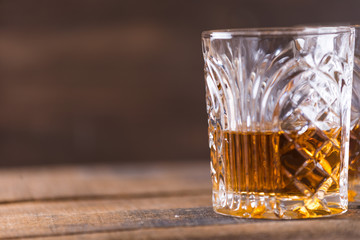 whiskey in glass on wood background