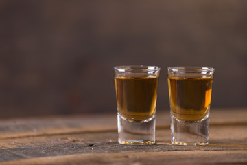 whiskey in glass on wood background