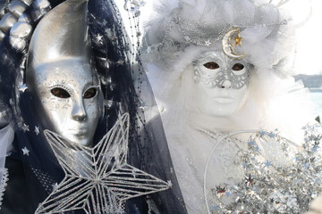 italy, carnival masks in venice posing near the sea