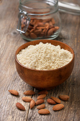almond flour in a wooden bowl, almonds