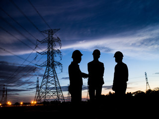 silhouette man of engineers standing at electricity station over - obrazy, fototapety, plakaty