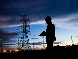 silhouette man of engineers standing at electricity station over