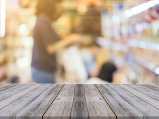 Wooden board empty table in front of blurred background. Perspective grey wood over blur store in mall - can be used for display or montage your products. vintage filtered image.