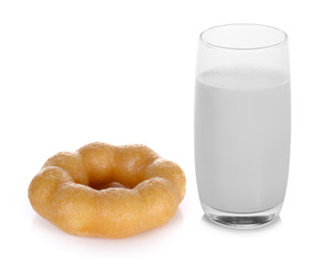 warm milk in the glass and donut on white background