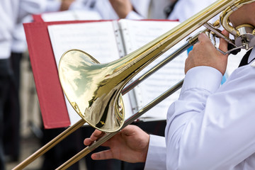 musician of military orchestra plays his trombone