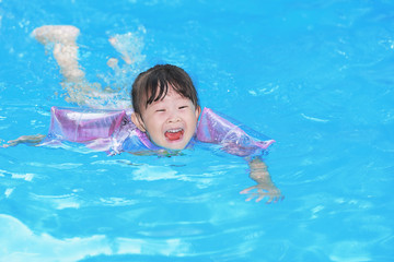 Happy little girl in the pool
