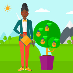 Woman watering tree with light bulbs.