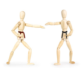 Two karate men are fighting. Abstract image with wooden puppets