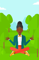 Business woman meditating in lotus pose.