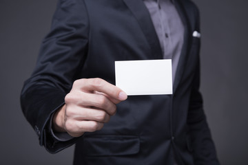 Businessman holding a card.