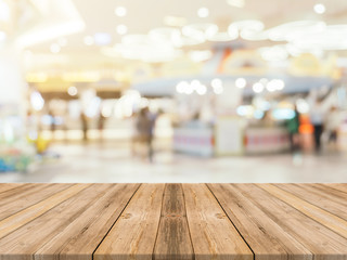 Wooden board empty table blurred background. Perspective brown wood over blur in department store -...