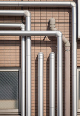 Pipeline water detail at industrial building wall