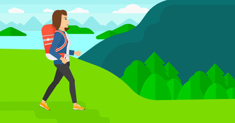 Woman with backpack hiking.