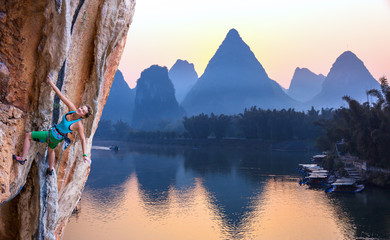 Bright Image of Young Rock Climber Sunrise karst Mountains in China and River