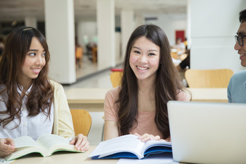Asian students working in the library.