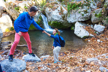 Two Hikers young Man and Smiling Woman holding hands