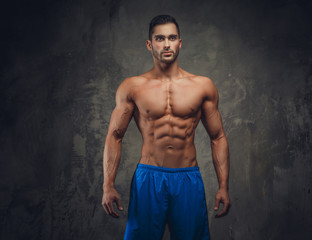 Shirtless muscular man posing.