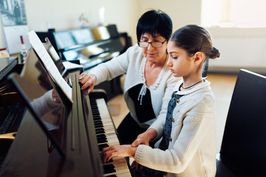  music teacher with the pupil at  lesson piano