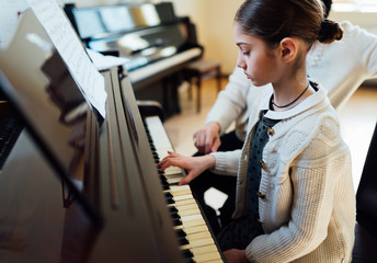  music teacher with the pupil at  lesson piano