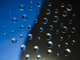drops of water on a black and blue background