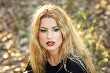 Fototapeta premium Relaxed girl lying on the field with long curly hair.