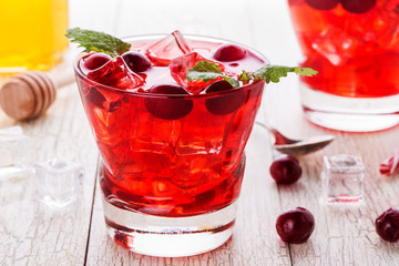 Cranberry cocktail with ice and mint.