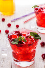 Cranberry cocktail with ice and mint.