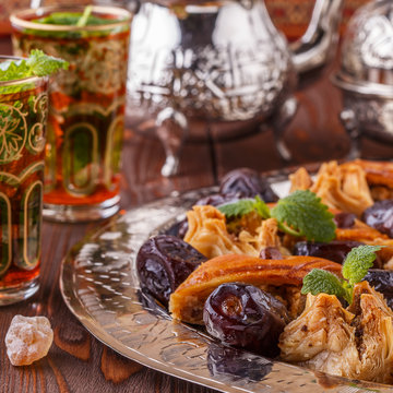 Moroccan mint tea in the traditional glasses with sweets.