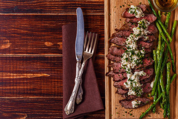 Steak with blue cheese sauce served with asparagus.