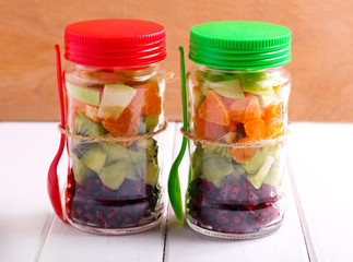 Fruits layered in glass jars