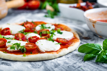 Prepering margherita pizza with mozzarella for baking - obrazy, fototapety, plakaty