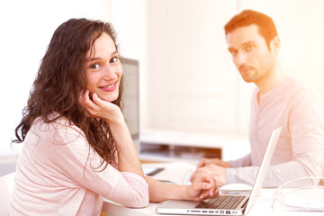 Man working with his co-worker on computer