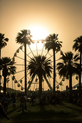 Fototapeta na wymiar Ferris Wheel Sunset. Ferris wheel in Coachella California caught in a sand storm at sunset.