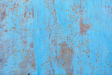 Peeling paint texture with rust stains. Old blue grunge background.