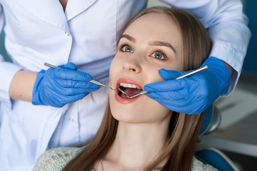 Dentist examining a patient's teeth in the dentist.