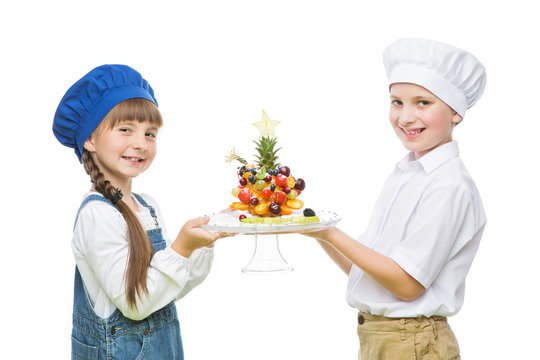 Children holding tree shape fruit snack