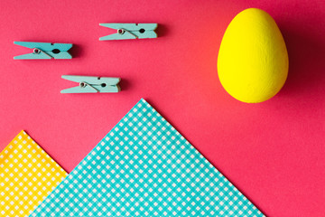 Easter egg and napkins on pink background