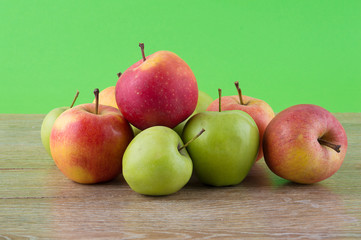 Apples colored, bright wooden background