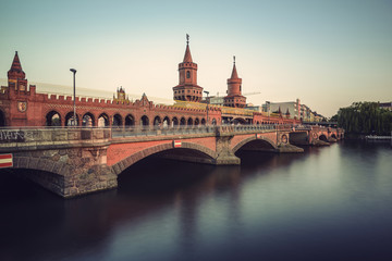 historical Oberbaum bridge (Oberbaumbruecke) and the river Spree in Berlin, Germany, Europe, vintage filtered style
